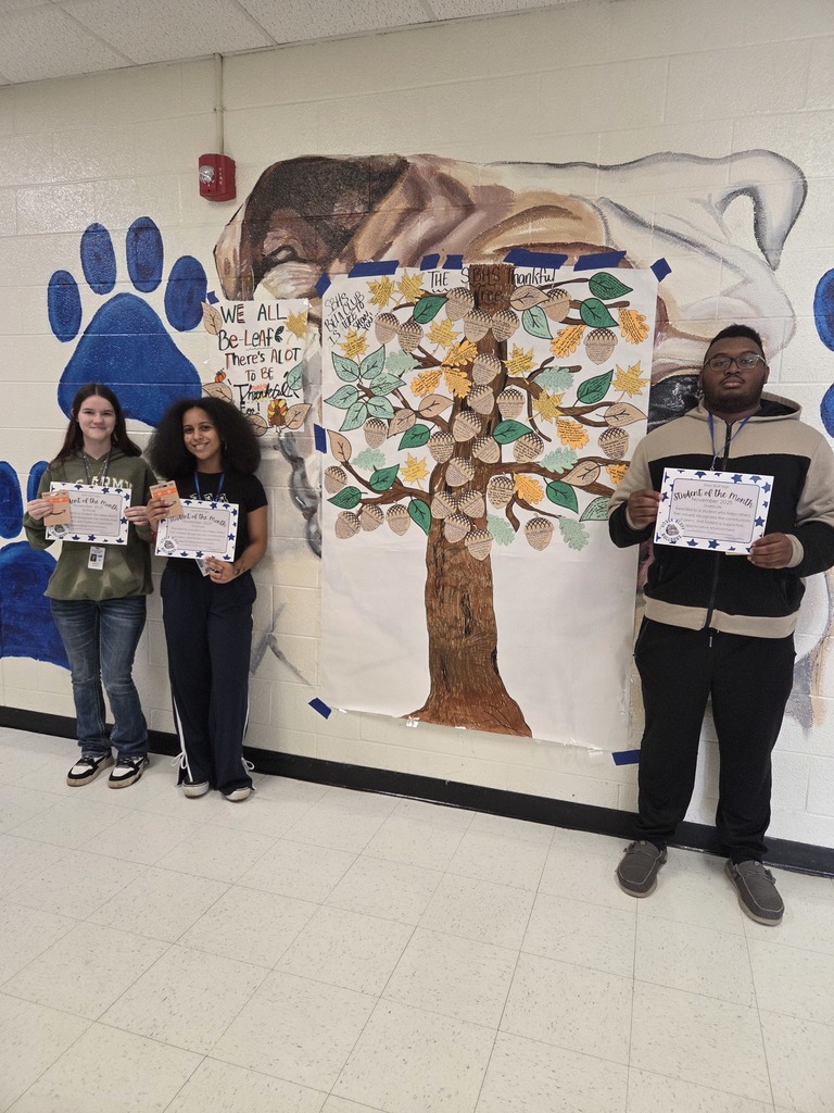 November Students of the Month posing in front of our gratitude tree