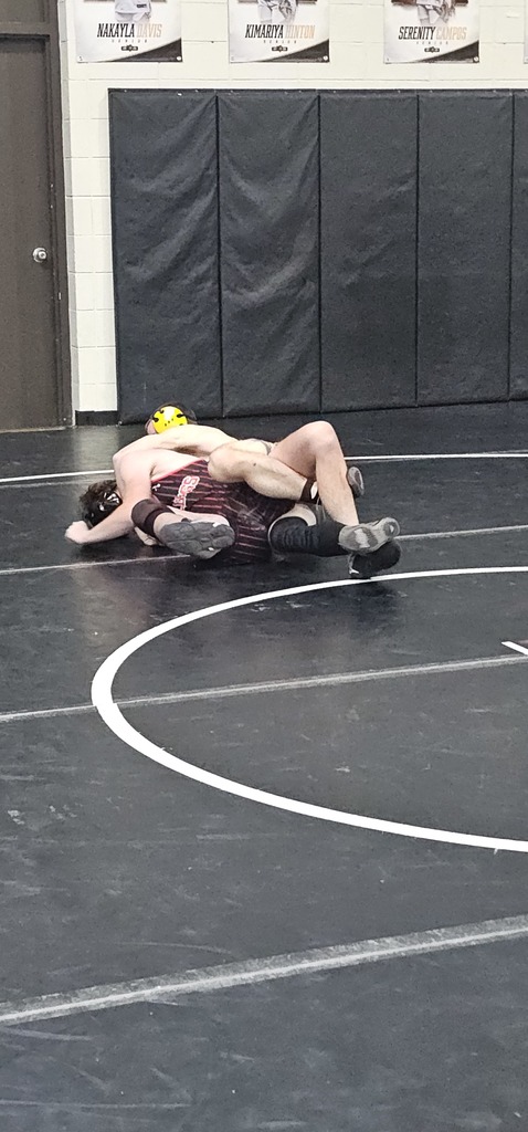 Male wrestlers in competition.