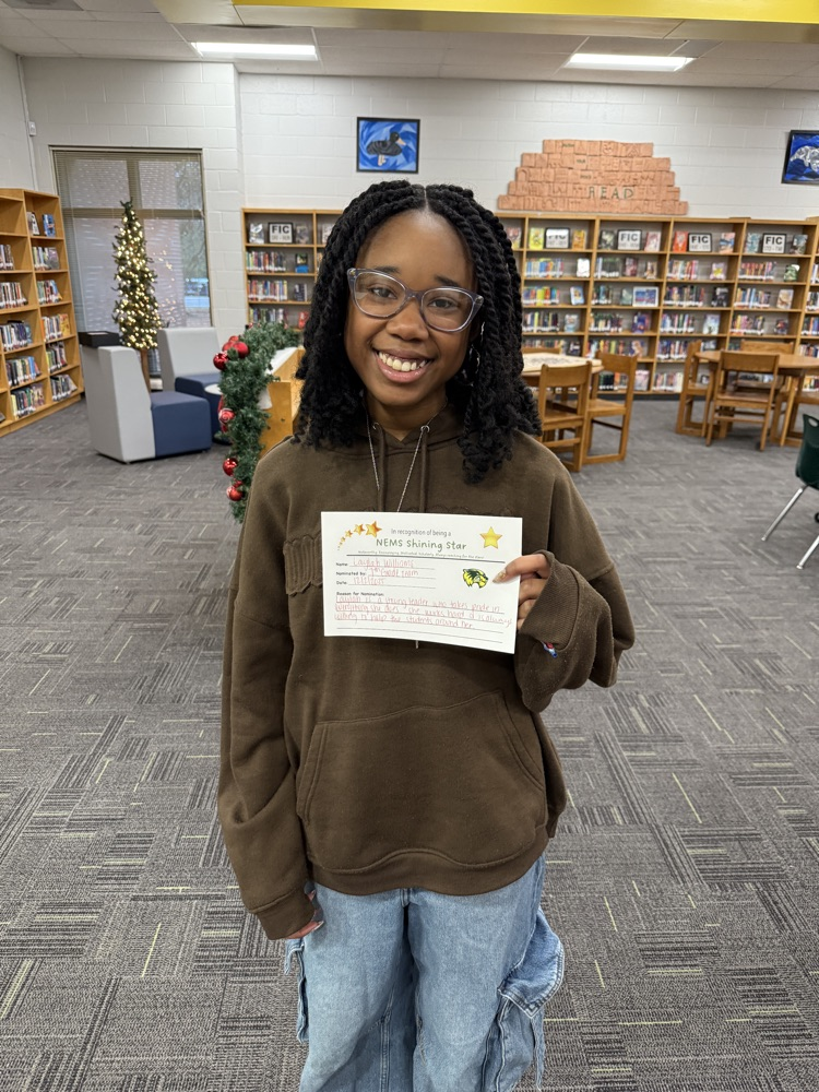 student posing with certificate 