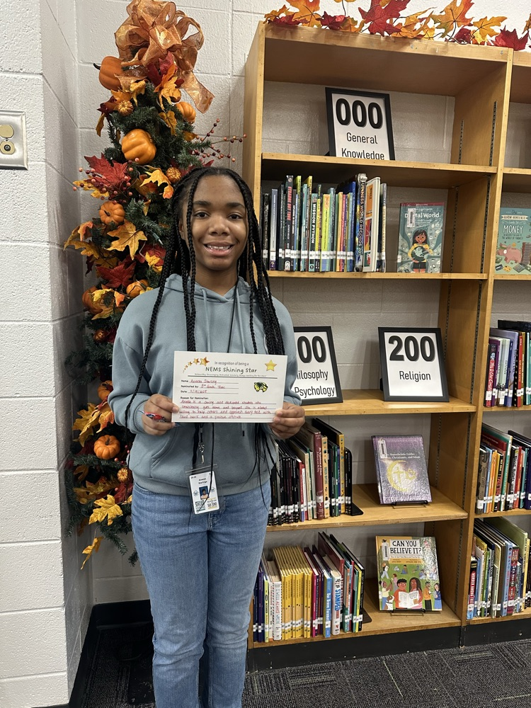 student posing with certificate 