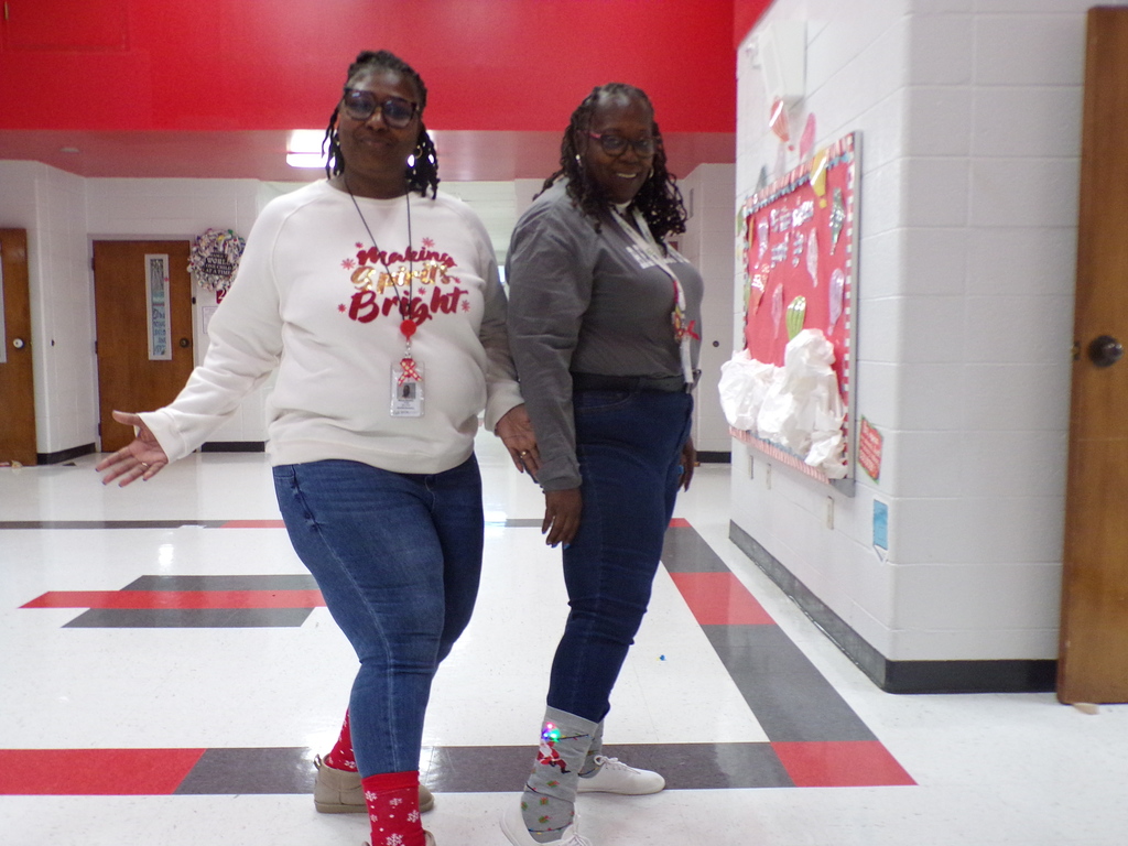 Staff wearing holiday socks.