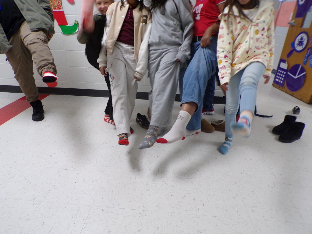 Students wearing holiday socks.