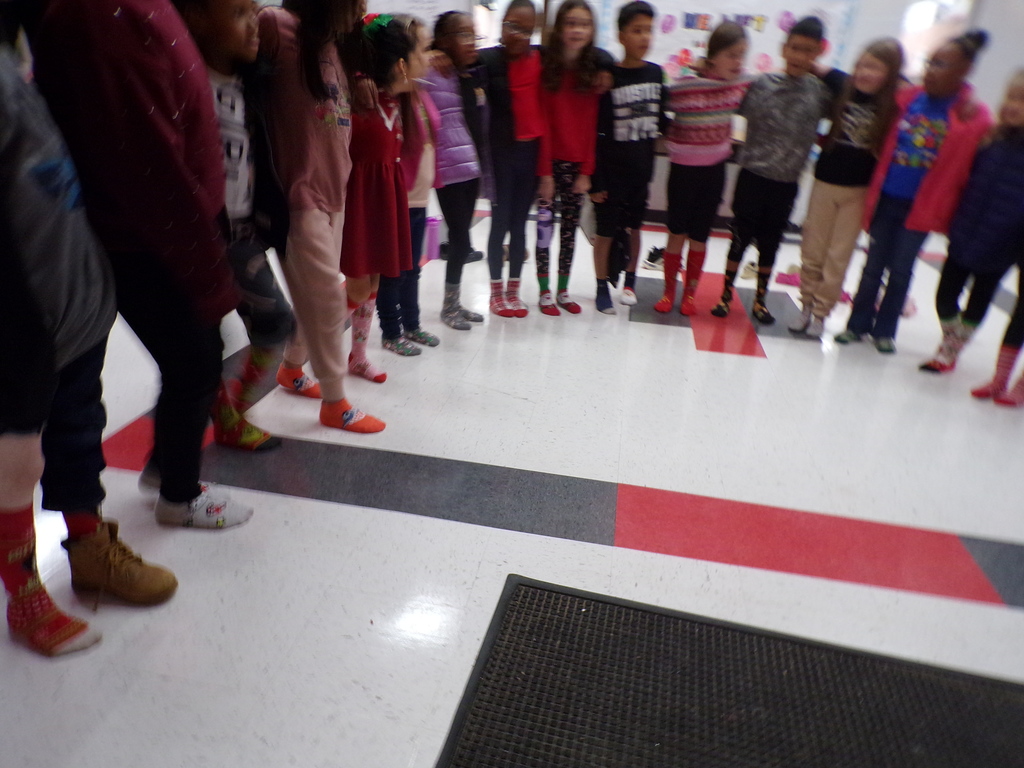 Students wearing holiday socks.