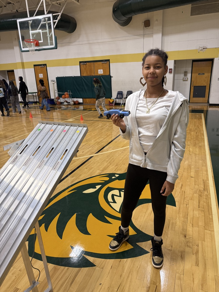 student holding a race car 