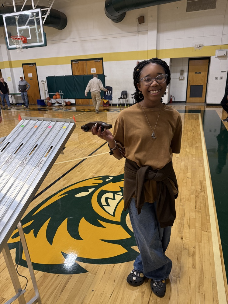 student holding a race car 
