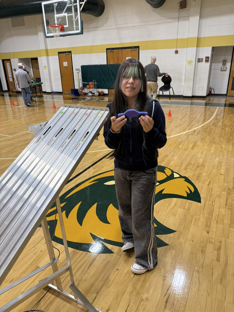 student holding a race car 