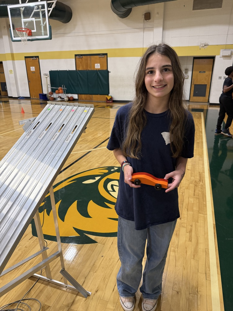 student holding a race car 