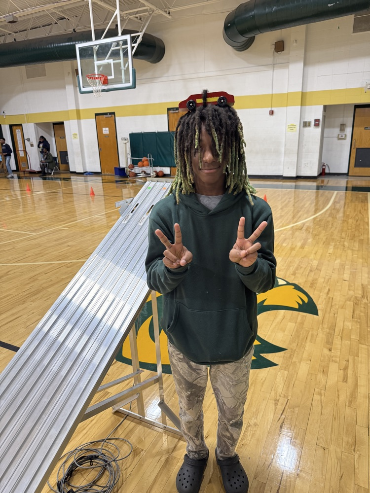 student holding a race car 