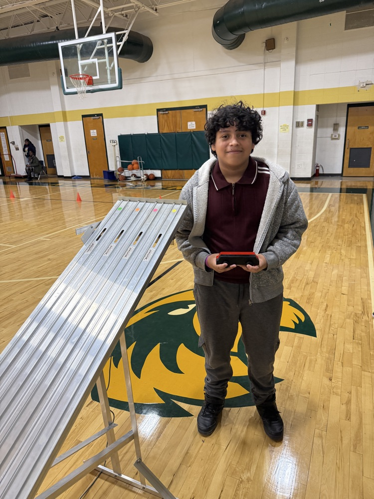 student holding a race car 