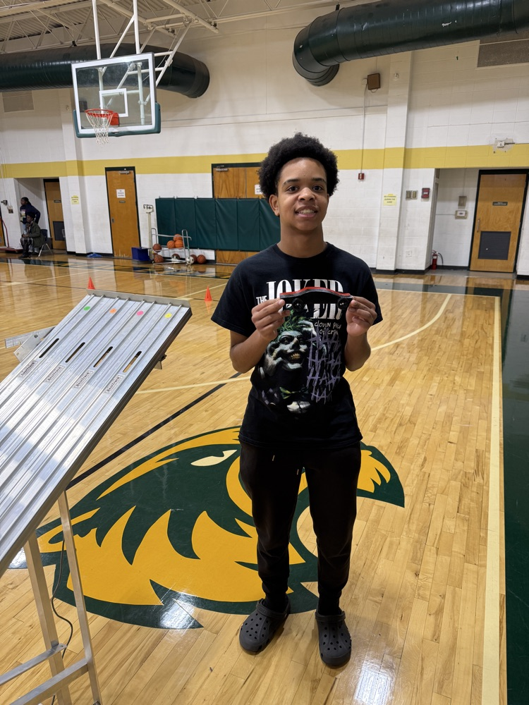 student holding a race car 