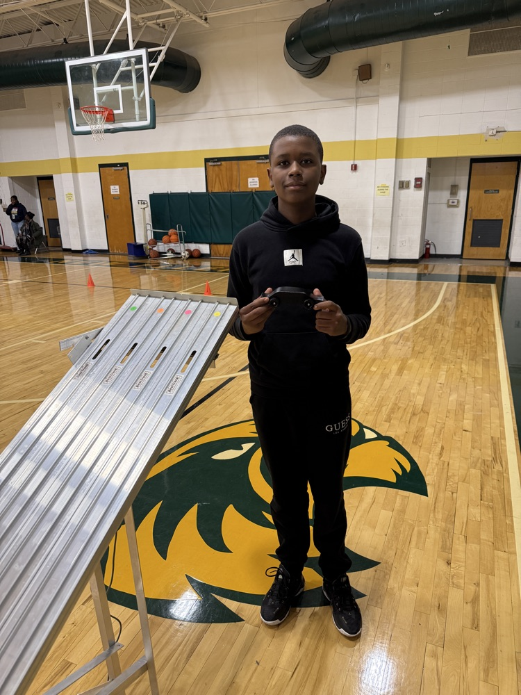 student holding a race car 