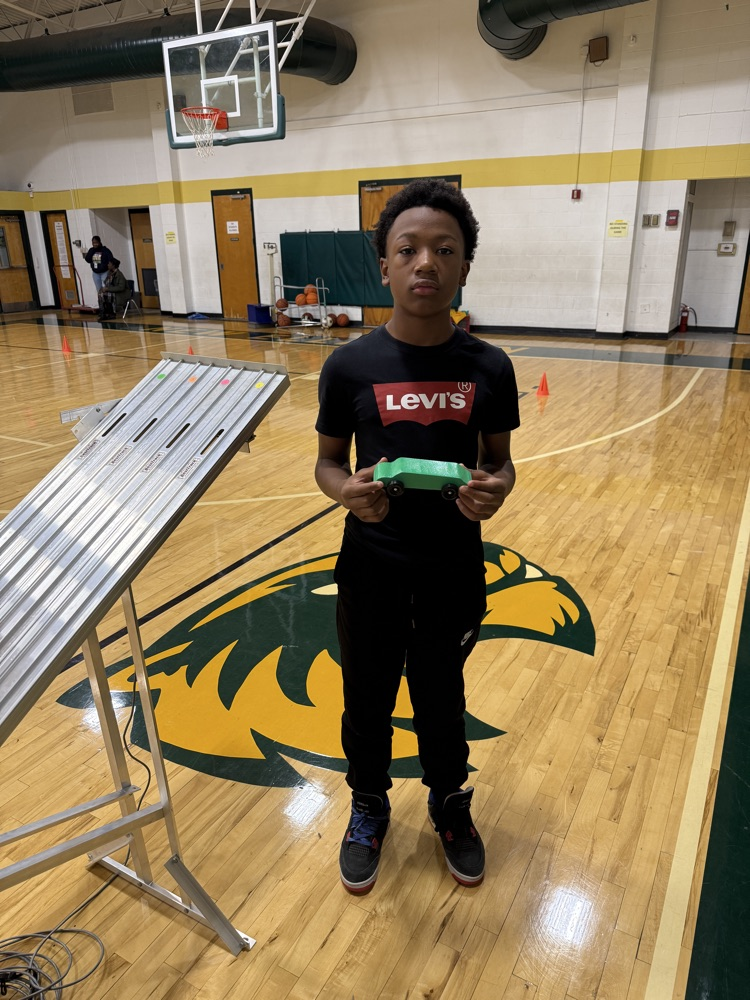 student holding a race car 