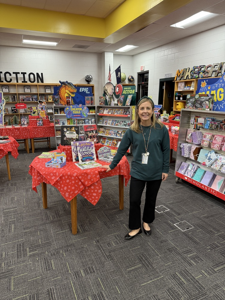 woman posing with book fair materials 