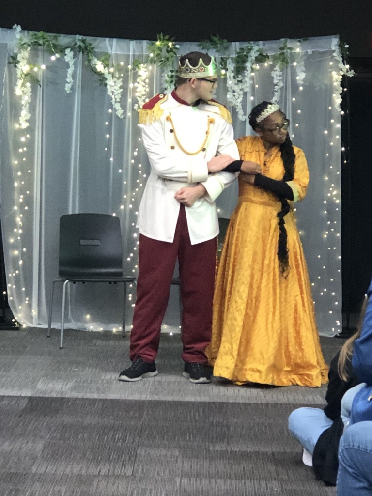 Girl and boy in costumes on stage. 
