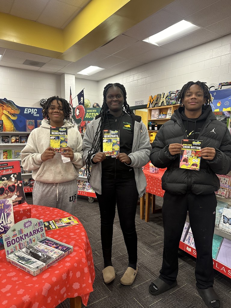 Students posing with books.
