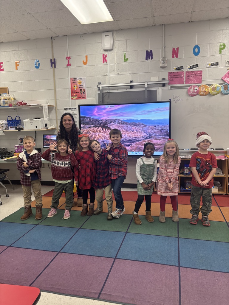 Students and staff dressed in Christmas attire.
