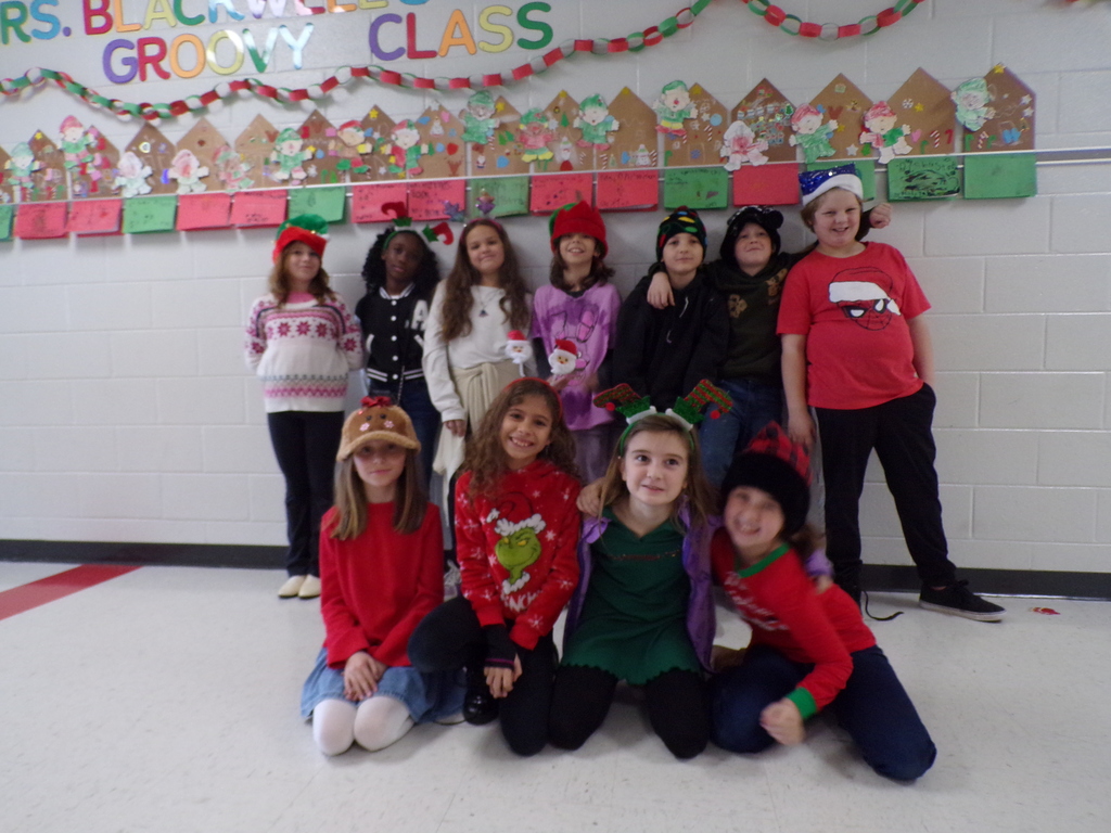 Students and staff dressed in holiday headwear.
