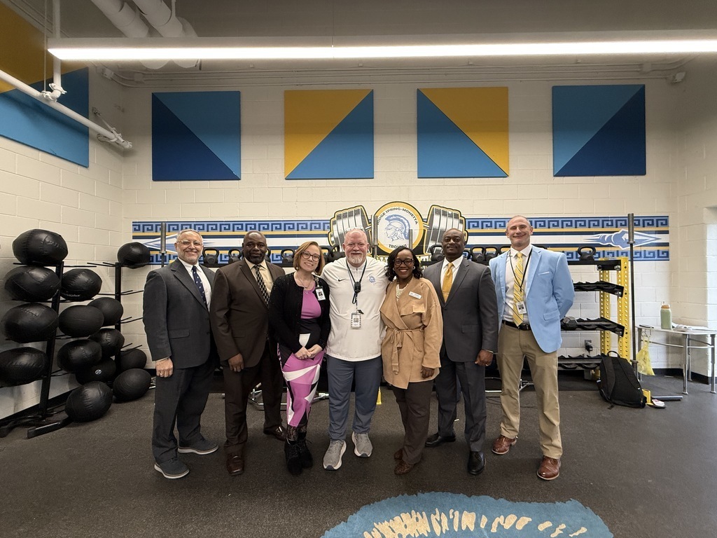 Seven School and District Leaders pose for a picture to celebrate Jerry Brannon, center, being named to the Teacher of the Year Honor Court.