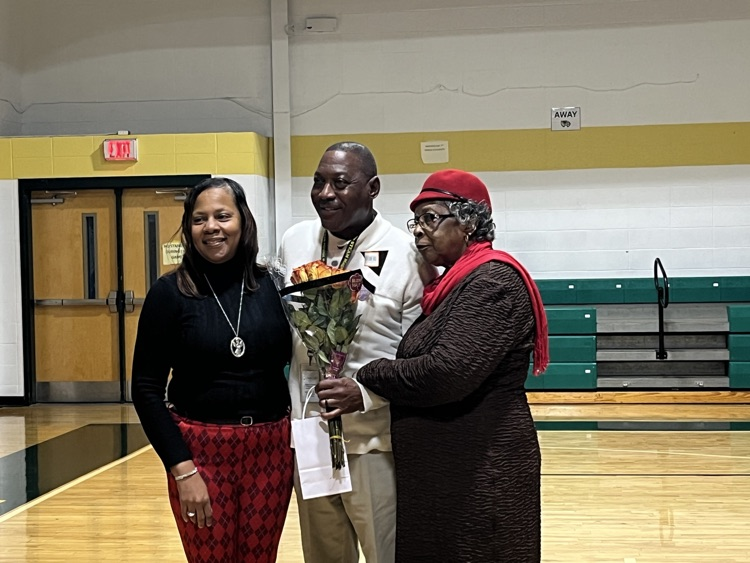 three people standing in a gym 