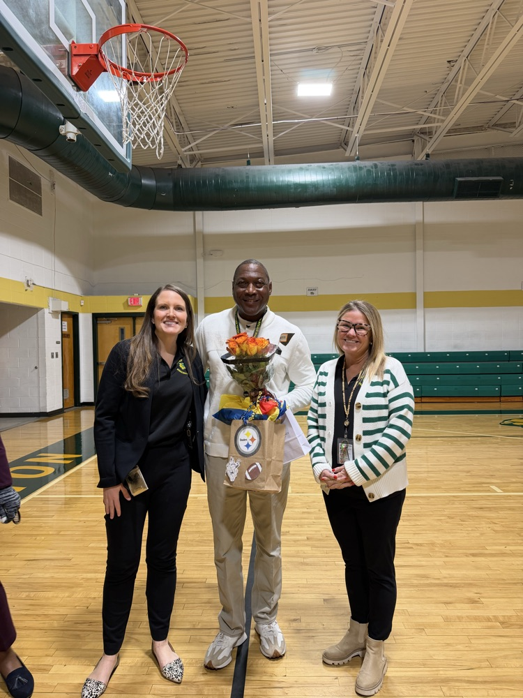three people standing in a gym 