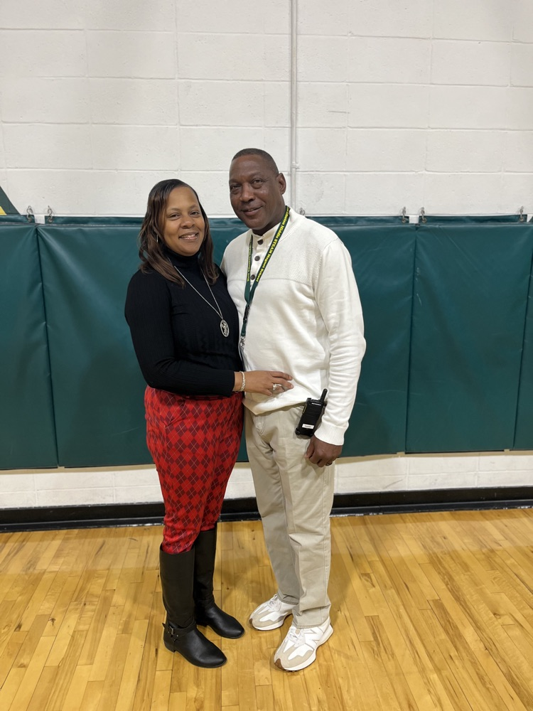 two people standing in a gym 