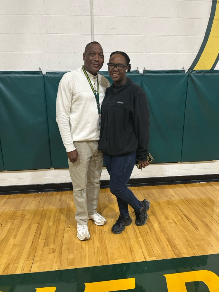 two people standing in a gym 