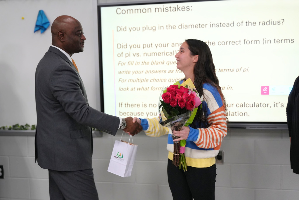 Superintendent Dr. Corey Murphy shaking hands with First Year Teacher of the Year honoree.