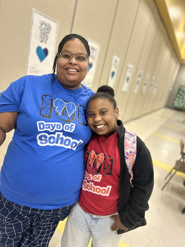 wearing 101st day of school shirts.
