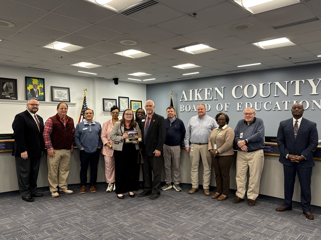 Aiken County Board of Education members are joined by Dr. Gary Senn and Kristie Brooks in receiving an administrative award