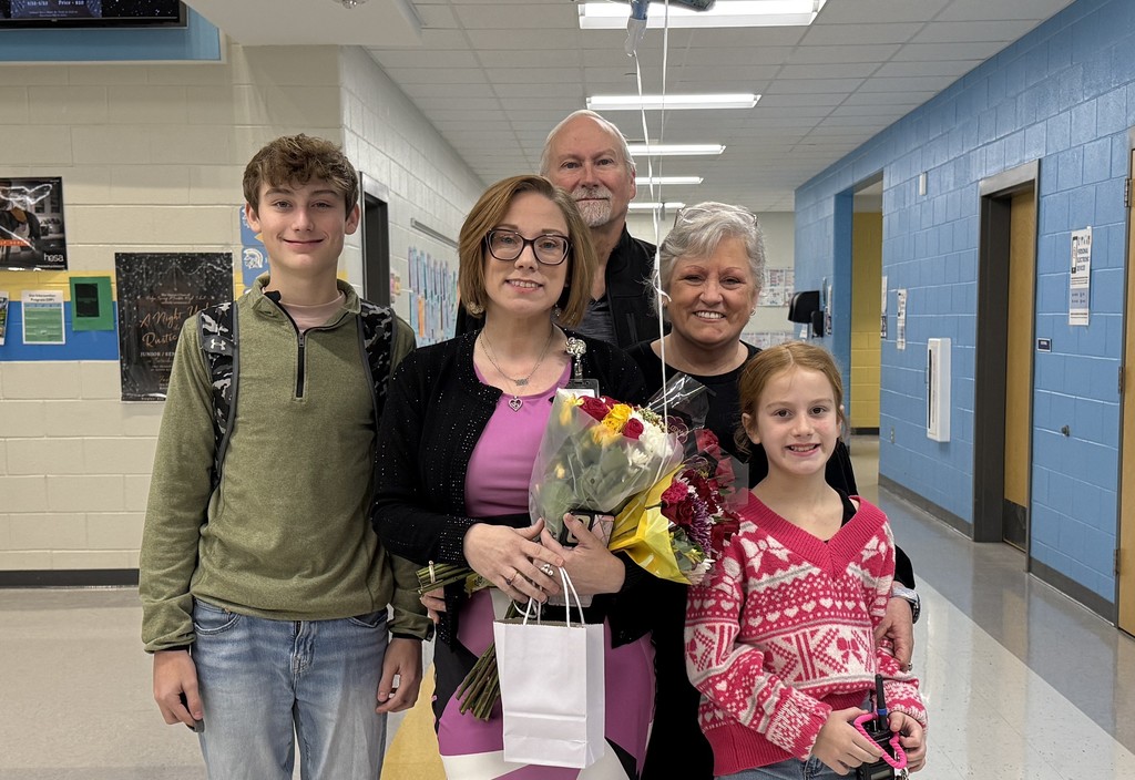 A family photo in a school hallway.