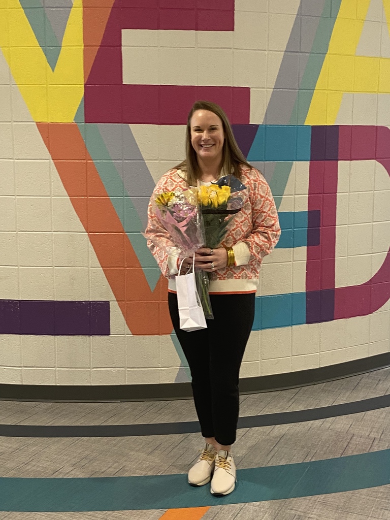 Woman stands with flowers as a celebration.