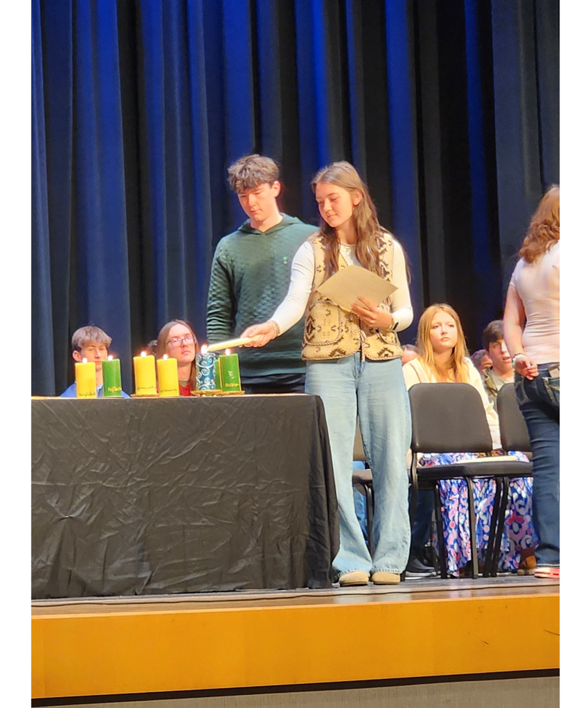 Student lighting a candle
