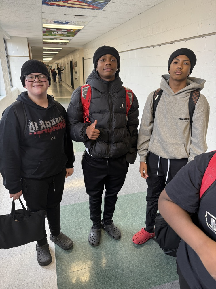 students posing for a picture wearing a beanie 