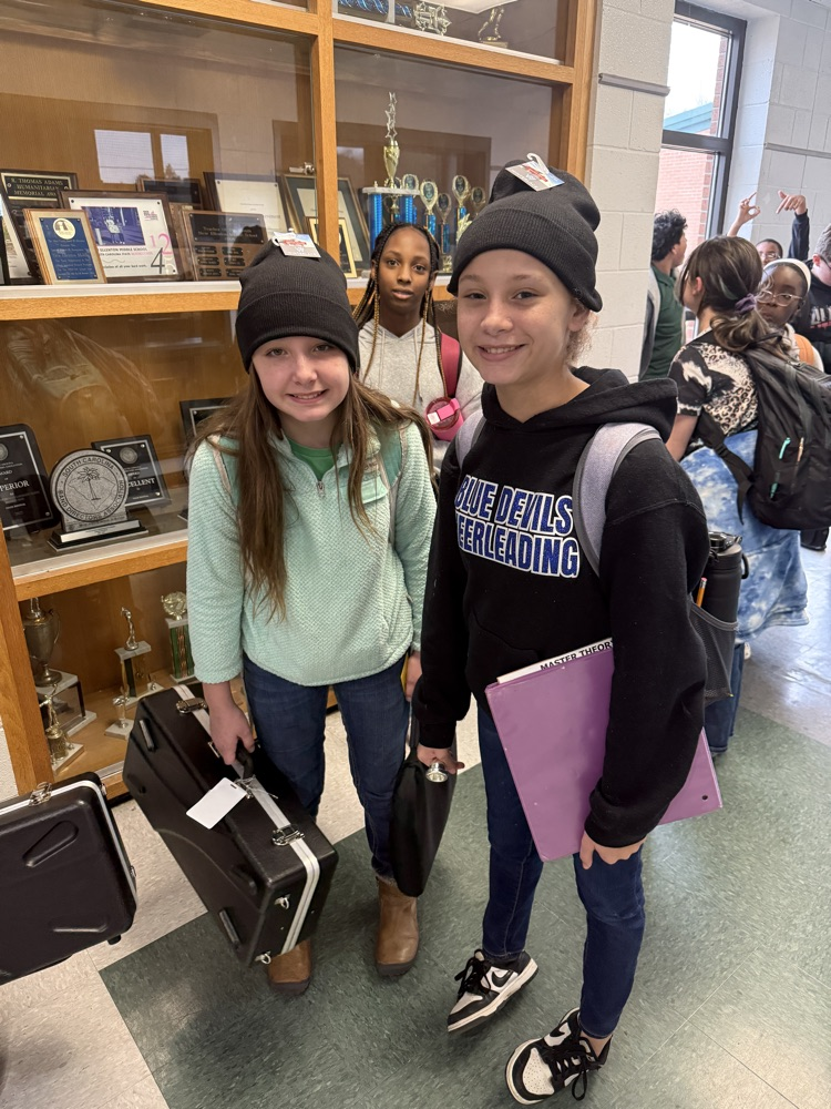 students posing for a picture wearing a beanie 