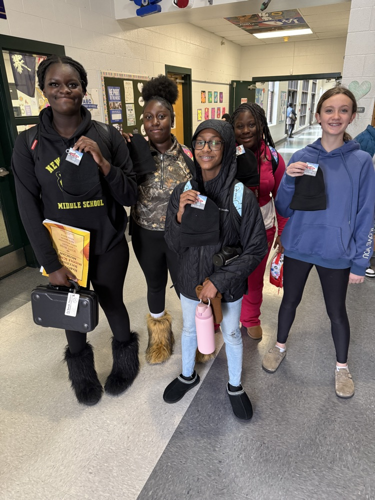 students posing for a picture wearing a beanie 