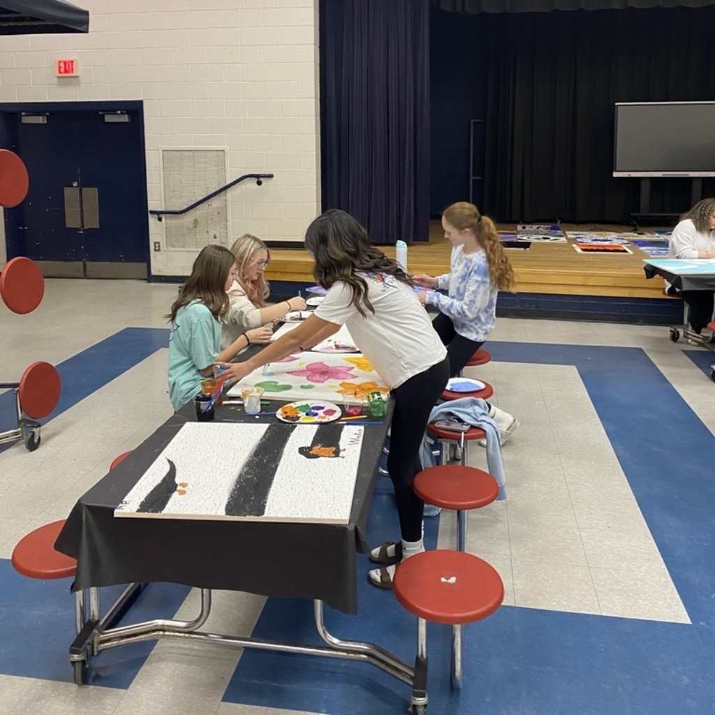 students painting ceiling tiles 