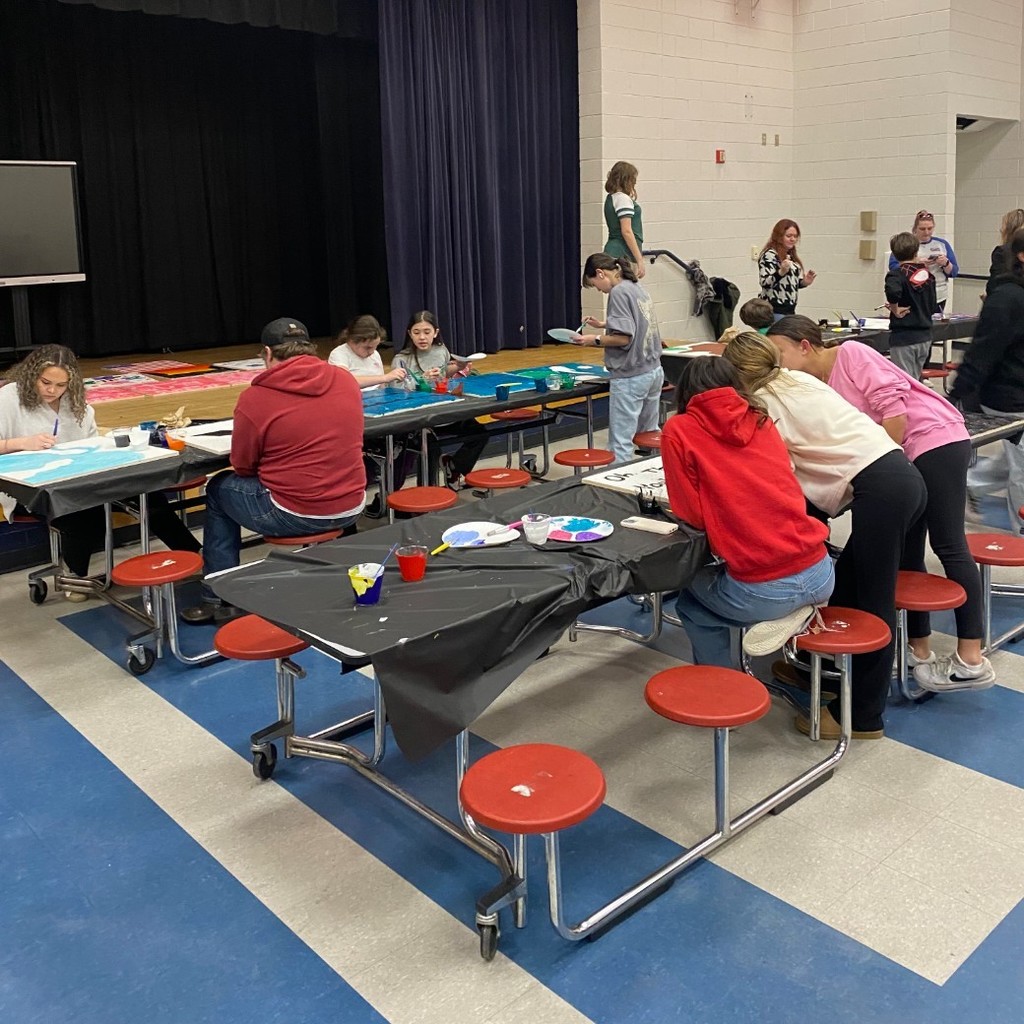people painting ceiling tiles