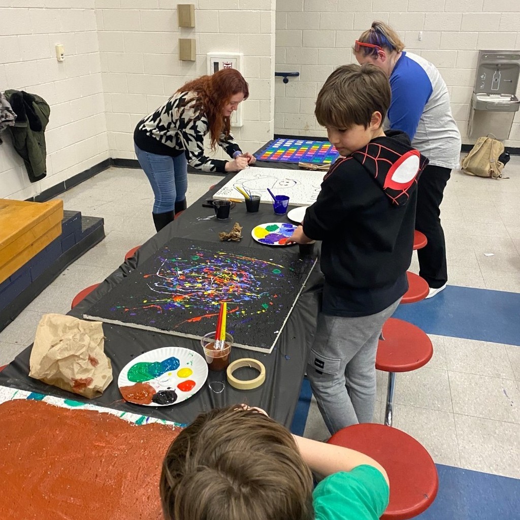people painting ceiling tiles 