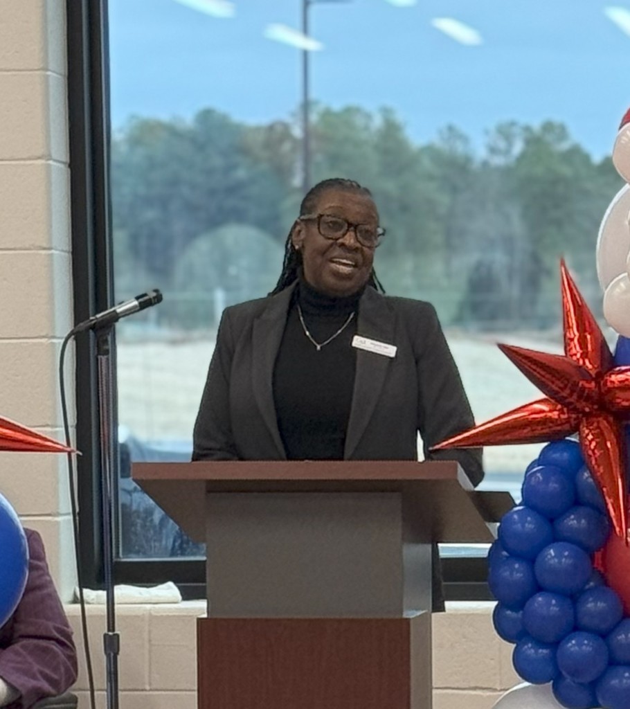 Board member speaking at event.