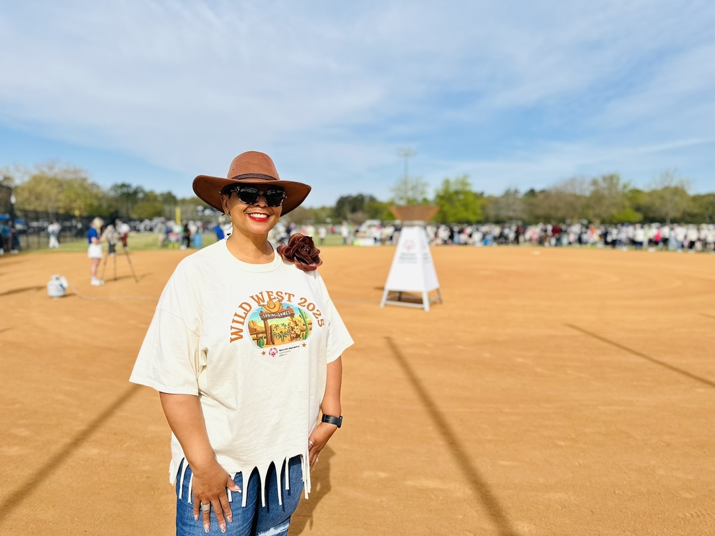 Board member smiling at field event.
