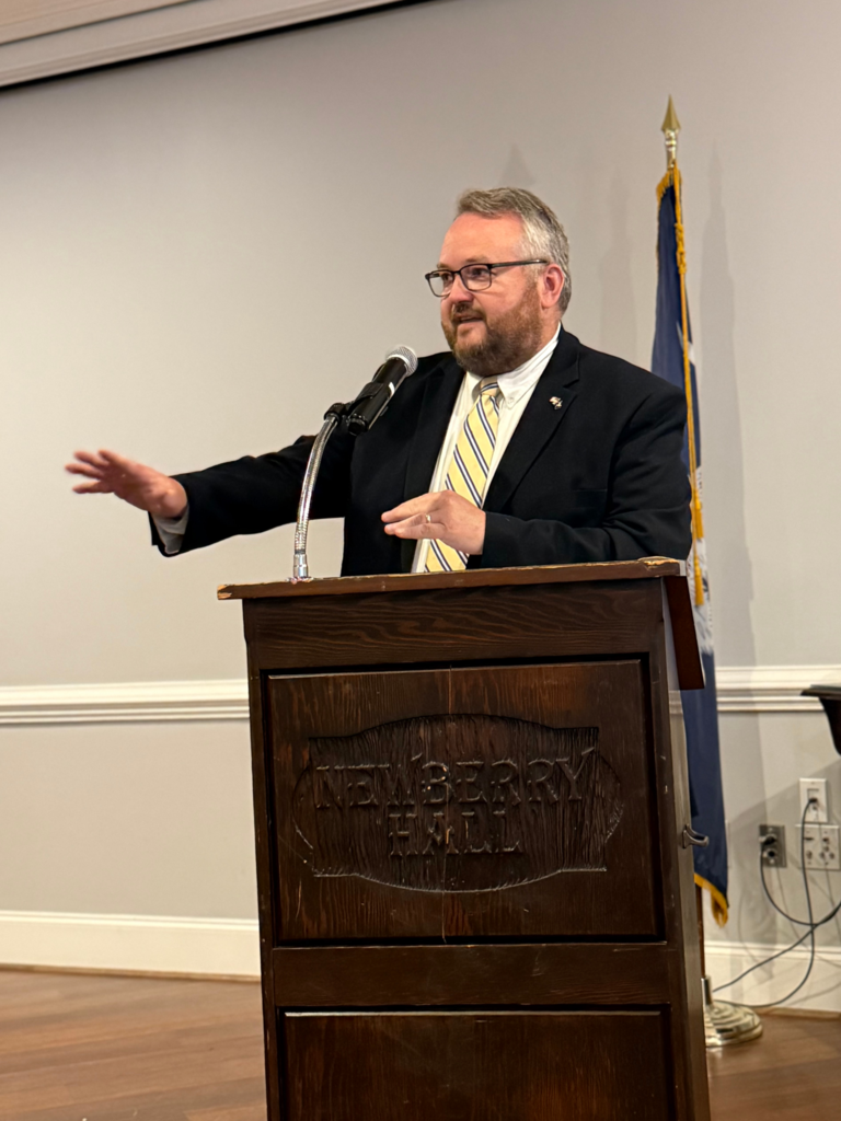 Board member speaking at event.