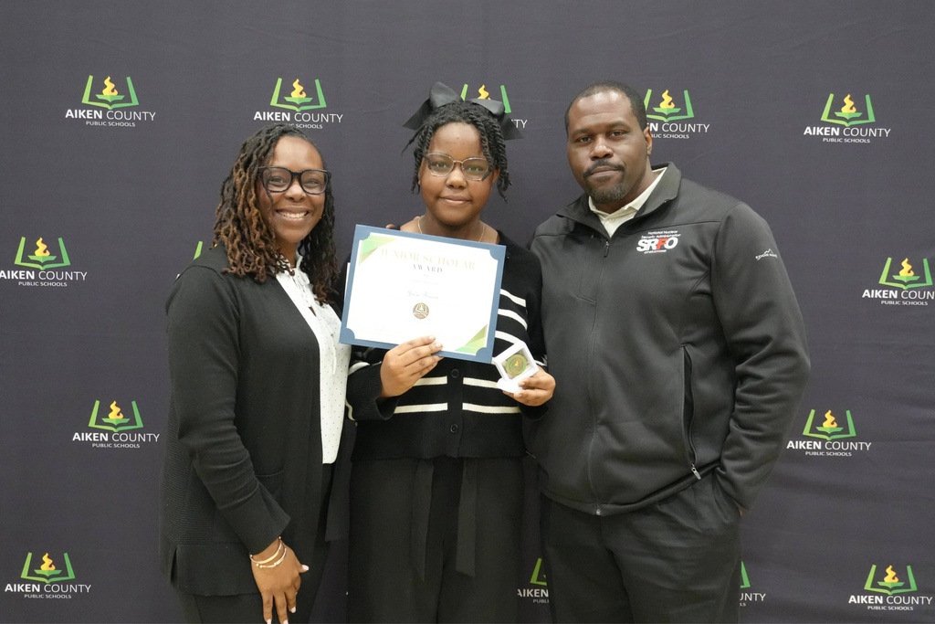 Family of student and student holding certificate.