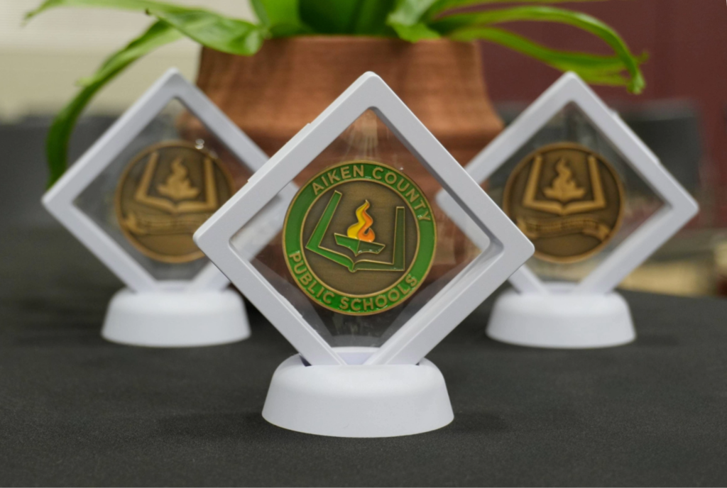 Coins inside protective award cases.