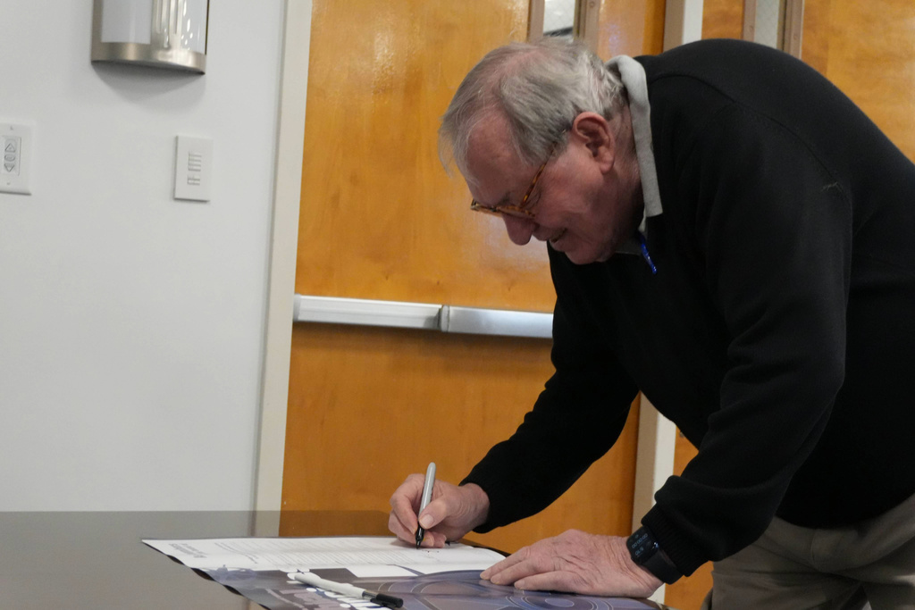 Board Members= smiling looking at poster.