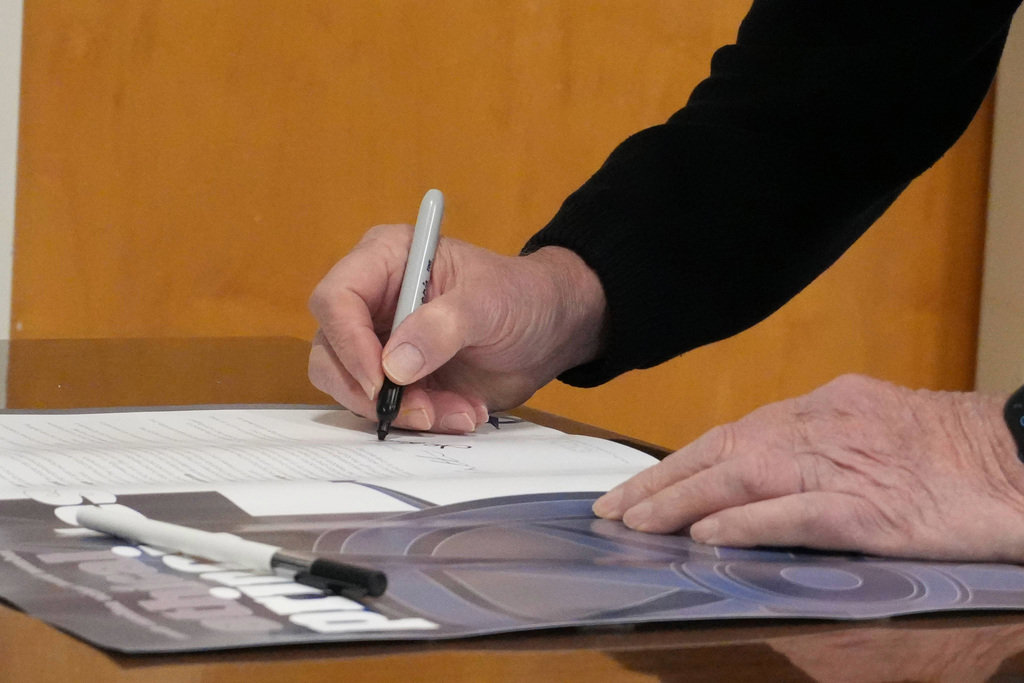 Colse up of hand holding pen.