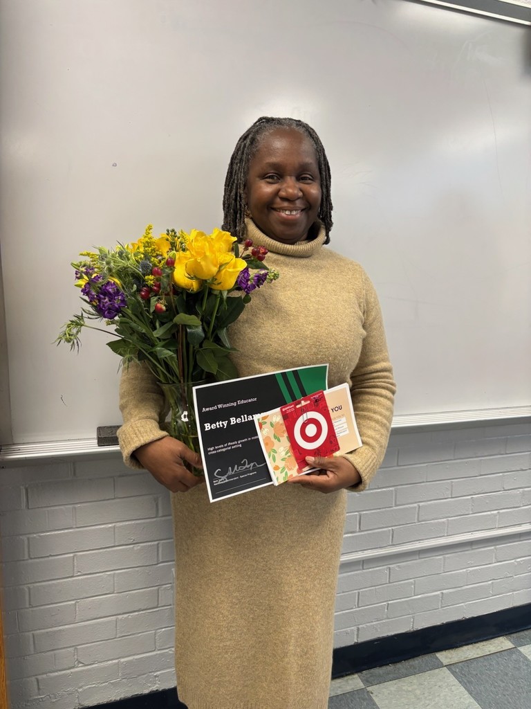 Picture of a lady holding flowers and a certificate