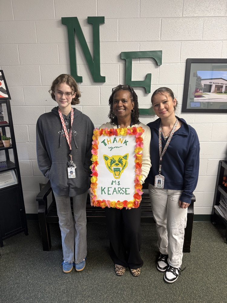 counselor and a student holding a sign 