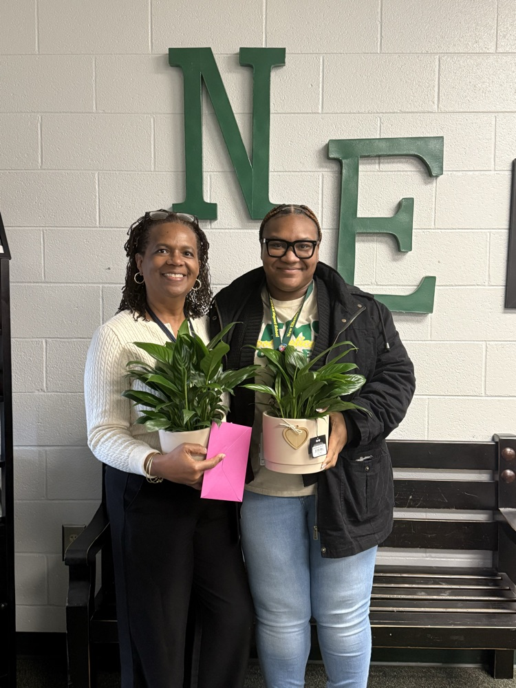 two women holding plants 