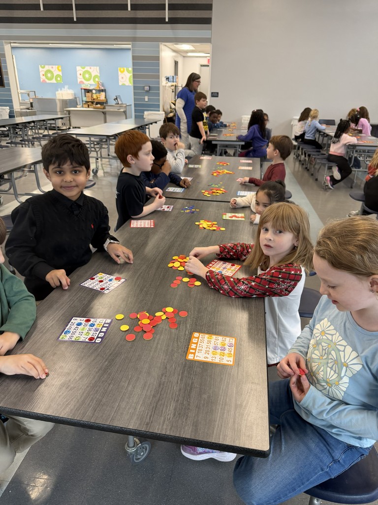 a group of children playing bingo in the school cafeteria