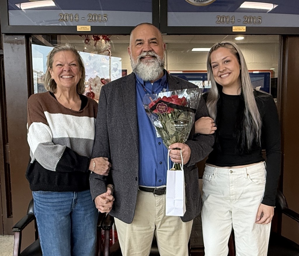 Principal Sheldon Higgenbottom, center, with his wife, left, and daughter, right.
